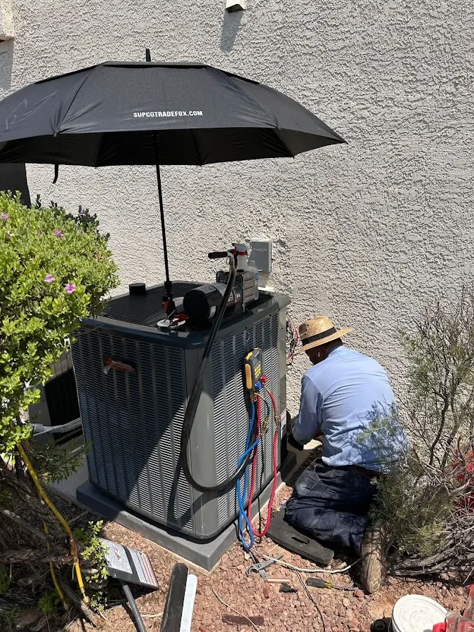 HVAC technician performing outdoor AC maintenance in Mehlville